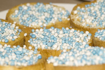 Cracker with butter and little colored balls, typical dutch delicacy when a  is bornの写真素材