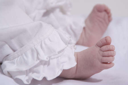 two small babyfeet of a babygirlの写真素材