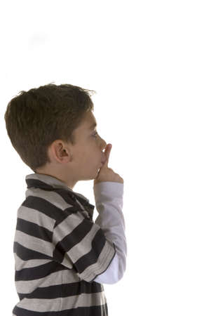 shh. secret - Young boy with his finger over his mouthの写真素材
