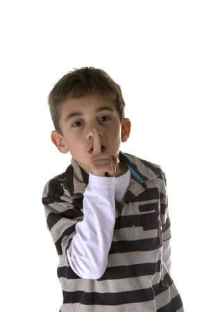 shh. secret - Young boy with his finger over his mouthの写真素材