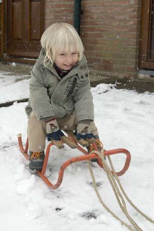 a boy on a sledの写真素材