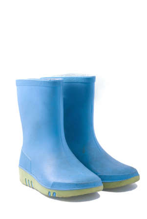 dirty blue rainboots, isolated on whiteの写真素材