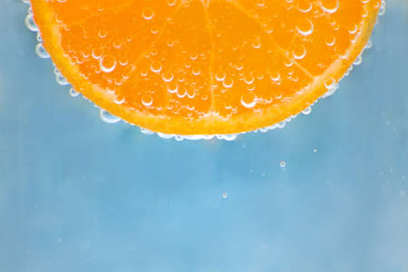 orange in water with bubblesの写真素材