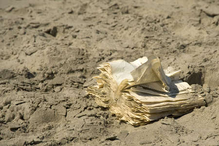 Old Book in the dutch language on shore of beachの写真素材