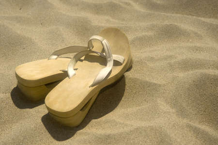 Flipflops on a sandy ocean beach - summer vacation conceptの写真素材