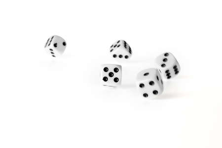 Five rolling dices, isolated on a white backgroundの写真素材
