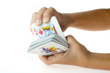 Two hands holding cards and showing the king