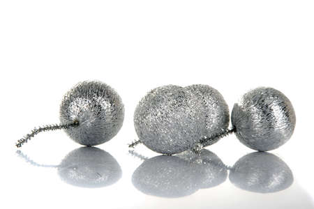 four silver christmas decoration on white