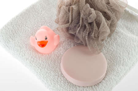 a towel with a sponge, soap and a rubber ducky