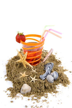 sand with a glass lemonade and sea shelvesの写真素材