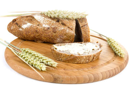 nut bread, butter and grain on a cutting boardの写真素材