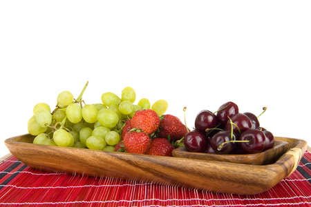 summerfruit in a wooden tray on a red plaidの写真素材