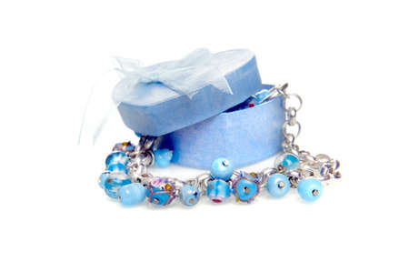 a blue heart box with jewellery on a white backgroundの写真素材