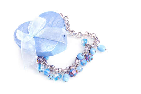 a blue heart box with jewellery on a white backgroundの写真素材