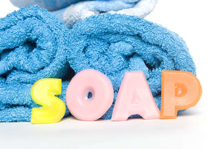 a blue towel and soap letters spelling soapの写真素材