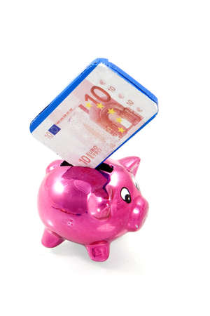a pink piggybank with chocolate banknoteの写真素材
