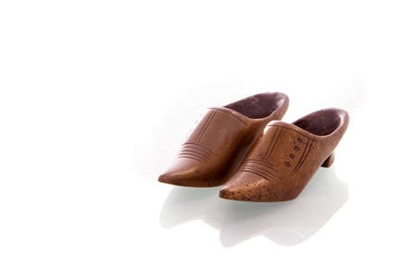 a pair of copper shoes on a white backgroundの写真素材