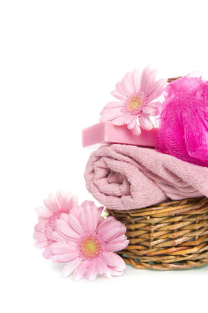 a towel, a sponge, soap and a flower in a basketの写真素材