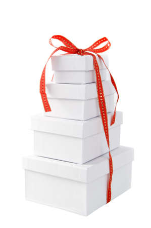 a pile of white presents with a red ribbon on a white backgroundの写真素材