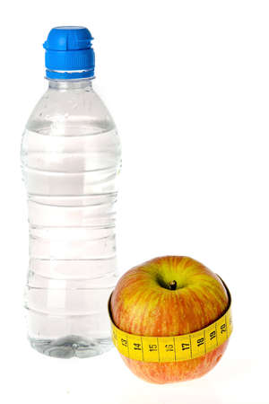a bottle of water and an apple on a white backgroundの写真素材