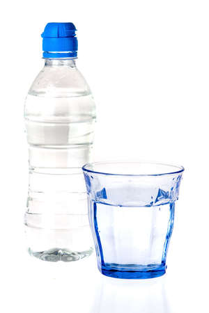 a blue glass and a bottle of water on a white backgroundの写真素材