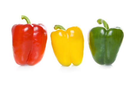 a red, a green and a yellow paprikaの写真素材