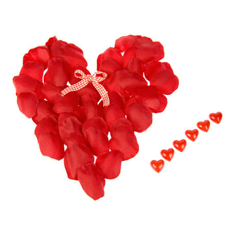a big heart - made of rose leaves - with a bow and six small heartsの写真素材