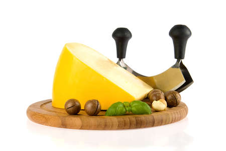 a kilogramm cheese, a cheese slicer and nutsの写真素材