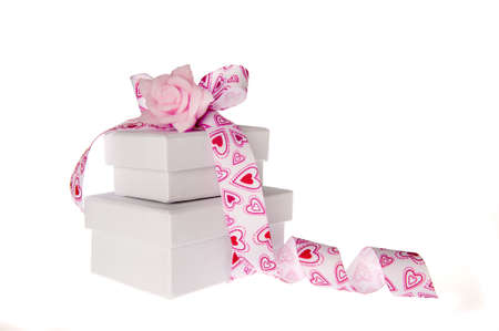 a pile of presents with a bow and a flowerの写真素材