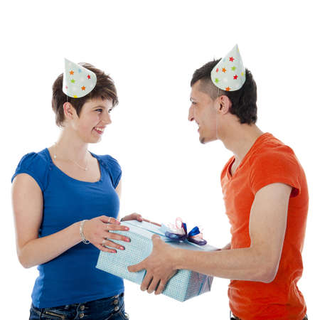 a happy boy is having a present for his birthday girl on a white backgroundの写真素材
