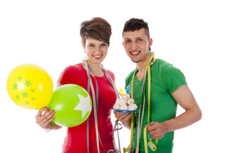 a boy and a girl with balloons and a birthdaycakeの写真素材
