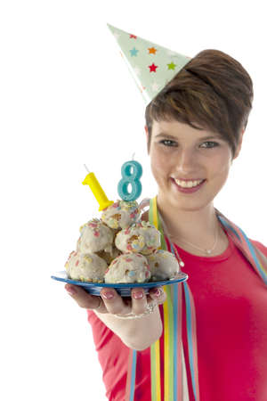 a birthday girl on her 18th birthday, holding a cake with a candle on a white backgroundの写真素材
