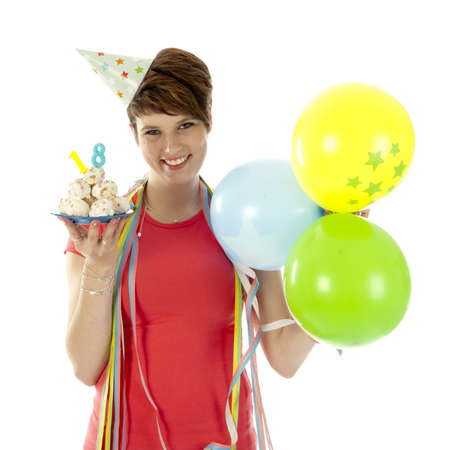 a birthday girl on her 18th birthday, holding a cake with a candle on a white backgroundの写真素材
