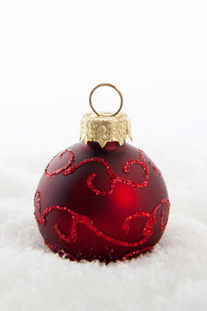 Red christmas ball in the snowの写真素材