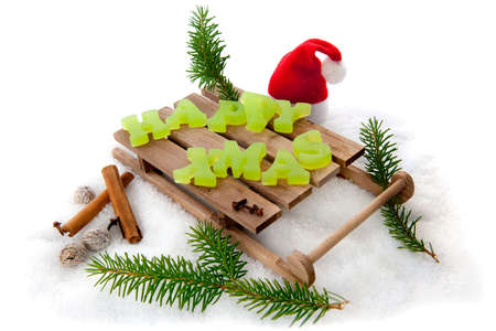 Happy Xmas on a wooden sleigh in the snowの写真素材