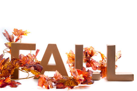Letters make the word Fall, with a lot of Autumn leaves