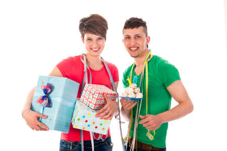 a birthdayboy and a birthdaygirl with a lot of presents an a birthdaycakeの写真素材