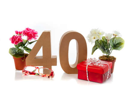 Celebrating your Fourtieth birthday, getting presents like reading glasses and a begoniaの写真素材