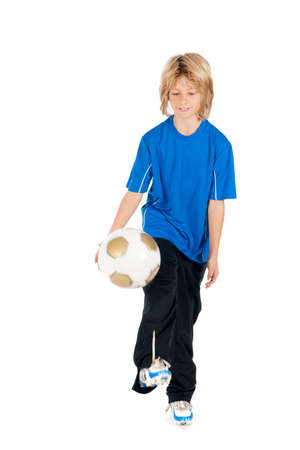 a young boy playing soccer on a white backgroundの写真素材