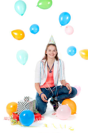 a birthday girl with presents and balloons on a white backgroundの写真素材