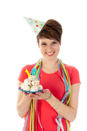 a birthday girl on her 18th birthday, holding a cake with a candleの写真素材