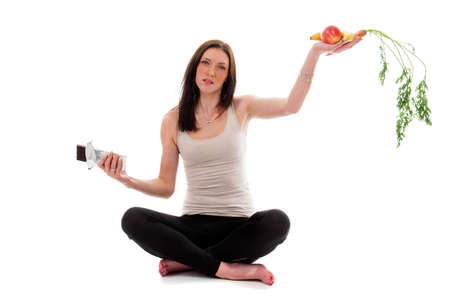 a girl on a diet, choose fruit and vegetables instead of chocolateの写真素材