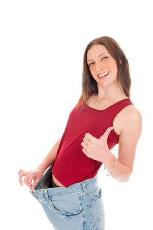 a girl celebrating her success of loosing weightの写真素材