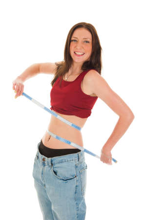 a girl with a measure tape, celebrating her success of loosing weightの写真素材