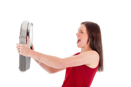 a angry girl with a weighing scaleの写真素材