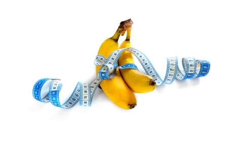 a banana with a tape-measure on a white backgroundの写真素材