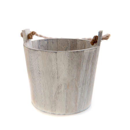 a wooden bucket with a rope on a white の写真素材
