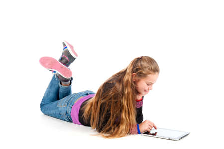 a beautiful young and modern girl playing with a tablet の写真素材