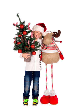 a boy with Rudolph and a christmas tree on a white backgroundの写真素材