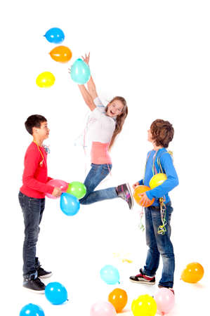 a birthday girl with two friends and balloons on a white backgroundの写真素材